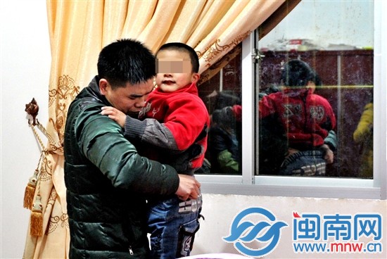 爸爸許先生，為玩鬧的小兒子整理褲子